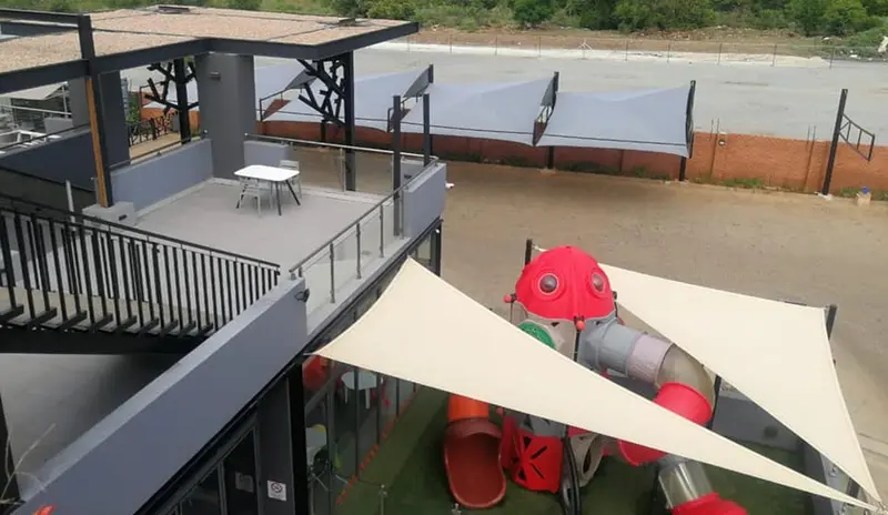 Triangle shade sail over playground